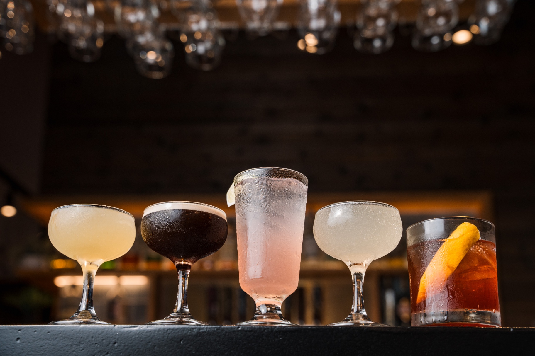 Signature cocktails lined up at the bar